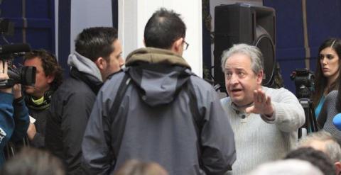 Alberto Casillas, con los agentes de policía de paisano que intentaron calmarle, en la sala donde iba a realizar Juan Carlos Monedero su comparecencia ante los periodistas. E.P.