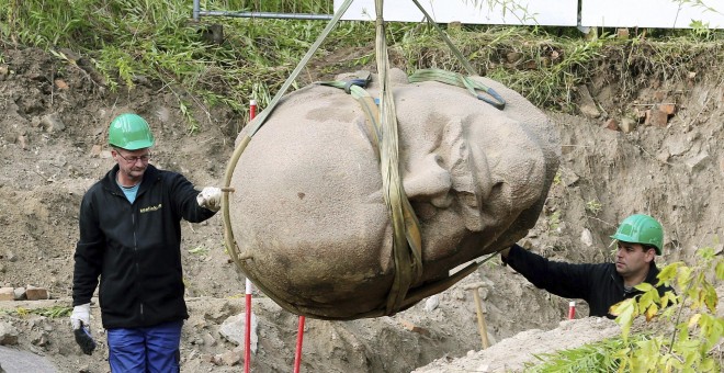 Trabajadores trasladan la cabeza de una escultura de Lenin en un bosque en Berlín (Alemania) hoy, 10 de septiembre de 2015. La cabeza del monumento de Lenin, que fue retirado en 1991, formará parte de la exposición 'Revelado. Berlín y sus Monumentos'. EFE