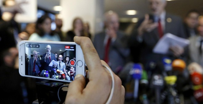 Un periodista graba en su teléfono móvil la comparecencia del embajador de Siria en la ONU, Bashar al Jaafari, por las conversaciones de paz de Ginebra. REUTERS/Denis Balibouse