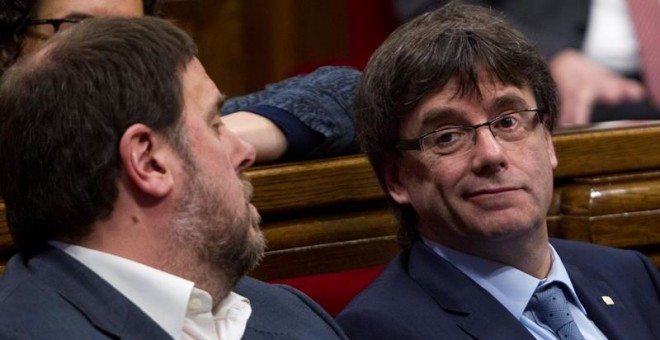 El presidente de la Generalitat, Carles Puigdemont, y su vicepresidente, Oriol Junqueras, durante la sesión de control al gobierno catalán que se celebra en el Parlament de Cataluña, un día después de la reunión del lider del PSOE, Pedro Sánchez, con el p