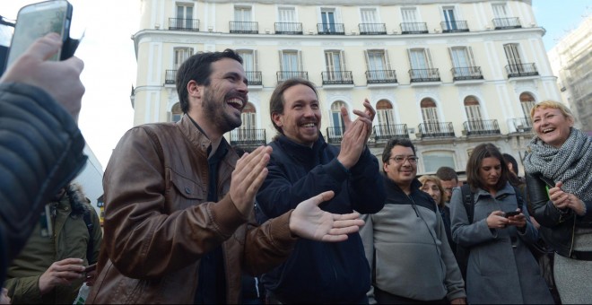 Alberto Garzón, líder de Izquierda Unida, y Pablo Iglesias, secretario general de Podemos, escenifican su acuerdo electoral en la Puerta del Sol de Madrid. PODEMOS