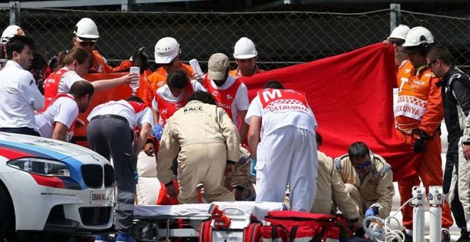 El piloto español de Moto2 Luis Salom, del equipo SAG Team, es atendido por los servicios sanitarios tras sufrir un accidente en la segunda sesión de entrenamientos libres del Gran Premio de Catalunya de motociclismo. EFE/Toni Albir