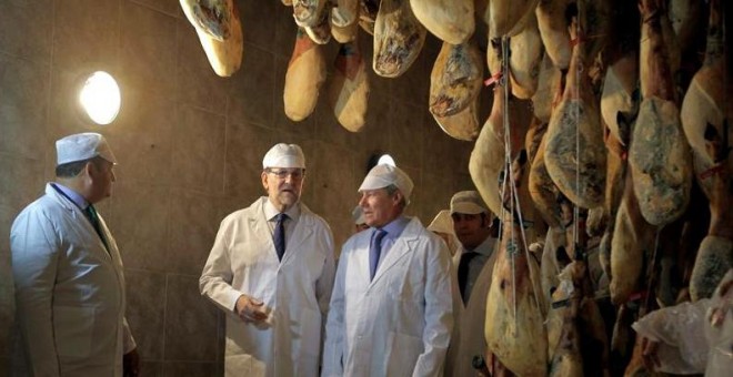 El presidente del Gobierno y líder del PP, Mariano Rajoy, acompañado del delegado del Gobierno de Andalucía, Antonio Sanz, durante la visita realizada este miércoles a la fábrica de embutidos y jamones Montesierra en la localidad gaditana de Jerez de la F