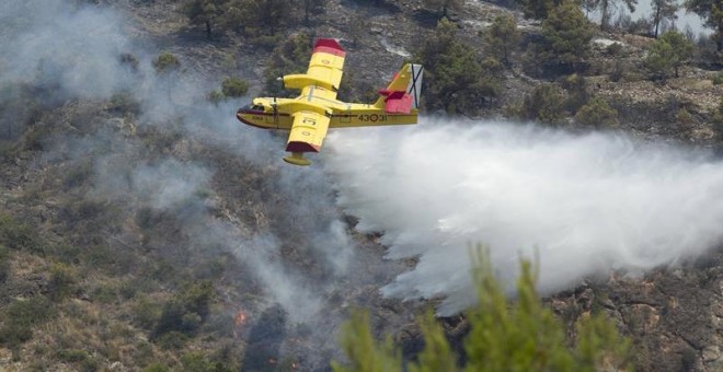 Medios aéreos trabajan en la extinción del incendio en el Parque Natural de la Serra d'Espadá en Artana (Castellón), que ha afectado hasta el momento mil hectáreas y está en proceso de estabilización, gracia a las labores de extinción y a la mejor climat
