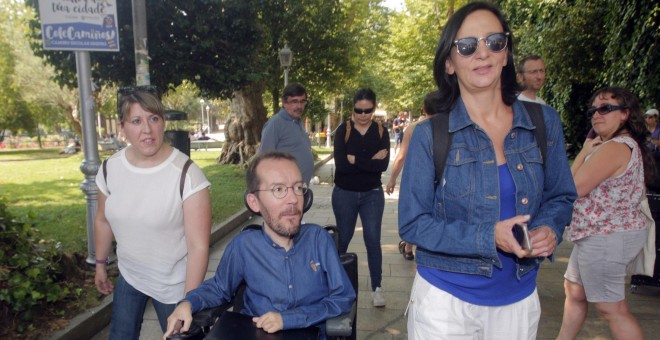 El secretario de Organización de Podemos, Pablo Echenique (c), junto a la secretaria de Análisis Político y Social, Carolina Bescansa (d), pasea por Santiago de Compostela tras la rueda de prensa sobre  las negociaciones con En Marea para las autonómigas