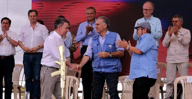 El presidente de Colombia, Juan Manuel Santos, el jefe de la Misión de la ONU en Colombia, Jean Arnault, y el líder de las FARC, 'Timochenko', en el acto de entrega de armas. /EFE