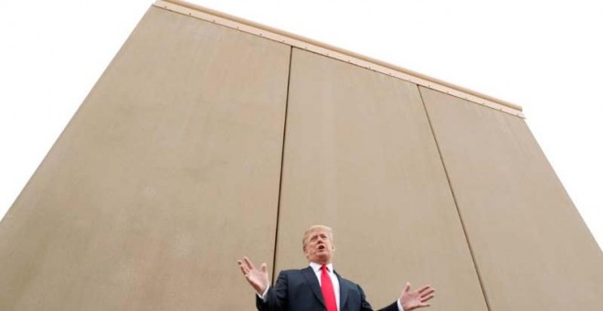 Trump, ante un prototipo del muro que quiere instalar en la frontera con México. | REUTERS