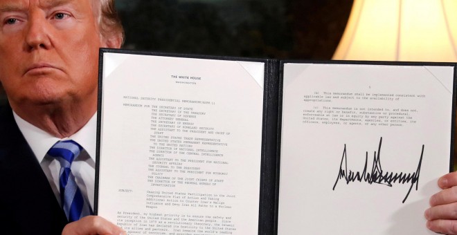 El presidente de EEUU, Donald Trump, muestra la declaración firmada sobre la retirada de su país del acuerdo nuclear con Irán, en la Sala Diplomática de la Casa Blanca, en Washington. REUTERS/Jonathan Ernst
