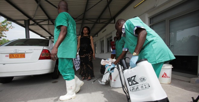 Un trabajador de sanidad rocía a un compañero con desinfectante durante una sesión de capacitación para tratar el virus del ébola en el Congo. REUTERS/Media Coulibaly/Archivo  Foto del 21 de octubre de 2014