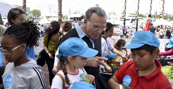 Isidro Fainé conversando con unos niños en el acto del Día del Voluntariado La Caixa en Barcelona.