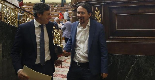 20/06/2018.-El líder de Podemos, Pablo Iglesias (d), conversa con el portavoz del PP, Rafael Hernando, durante la sesión de control al Gobierno, celebrada esta mañana en el Congreso de los Diputados. EFE/Javier Lizón