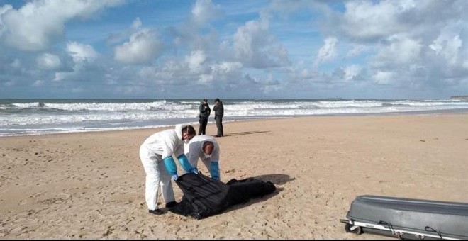 Operarios trasladan el cuerpo de uno de los migrantes del naufragio de la patera ocurrido el 5 de noviembre en Caños de Meca (Cádiz). / EFE