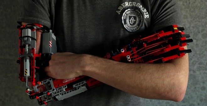 David Aguliar poses with his prosthetic arm built with Lego pieces during an interview with Reuters in Sant Cugat del Valles, near Barcelona, Spain, February 4, 2019. Picture taken on February 4, 2019. REUTERS/Albert Gea