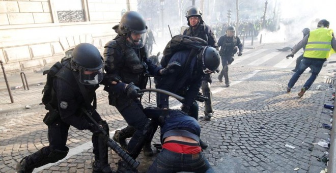 La Policía francesa golpea a un manifestante durante las protestas de los chalecos amarillos. REUTERS/Philippe Wojazer
