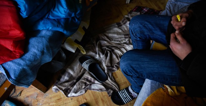 Un joven sentado en la que fue su cama entre septiembre y febrero en Velika Kladusa. - ANGÉLICA SÁNCHEZ