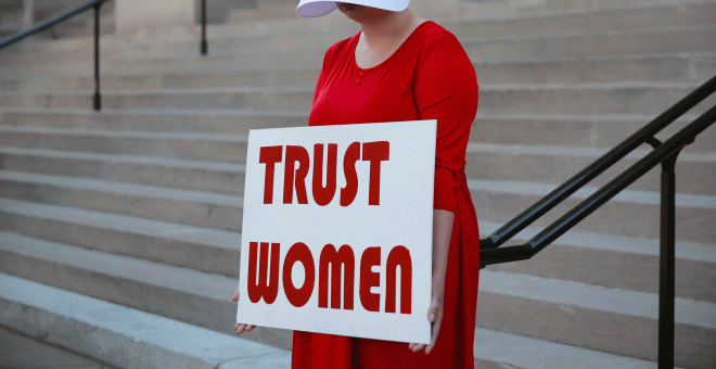 07/05/2019 - Una mujer vestida como sierva sostiene un letrero que dice 'Confíe en las mujeres' en protesta por el proyecto de ley de 'heartbeat' contra el aborto en Georgia | REUTERS/ Elijah Nouvelage