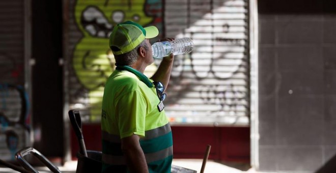 Un empleado de limpieza del ayuntamiento de Madrid bebe agua, una de las medidas recomendadas para evitar los golpes de calor y la deshidratración en sta calurosa mañana de sábado de agosto. EFE/MARISCAL