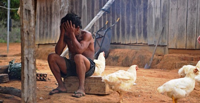 Un miembro de la tribu Uru Eu Wau Wau se cubre el rostro en la reserva de la tribu en el Amazonas, al sur de Porto Velho, Brasil. - CARL DE SOUZA / AFP