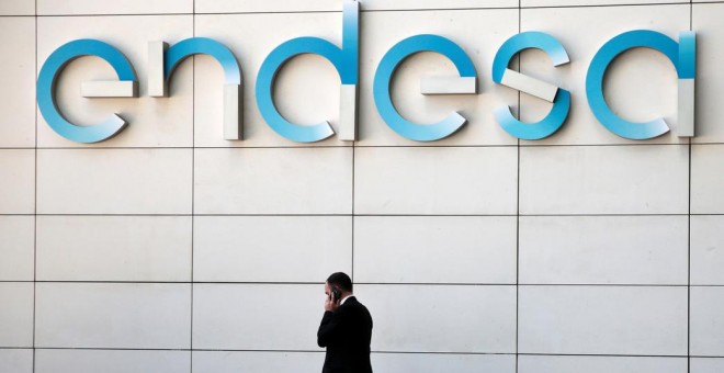 Un hombre camina bajo el logo de Endesa en la sede de la empresa en Madrid. REUTERS/Andrea Comas