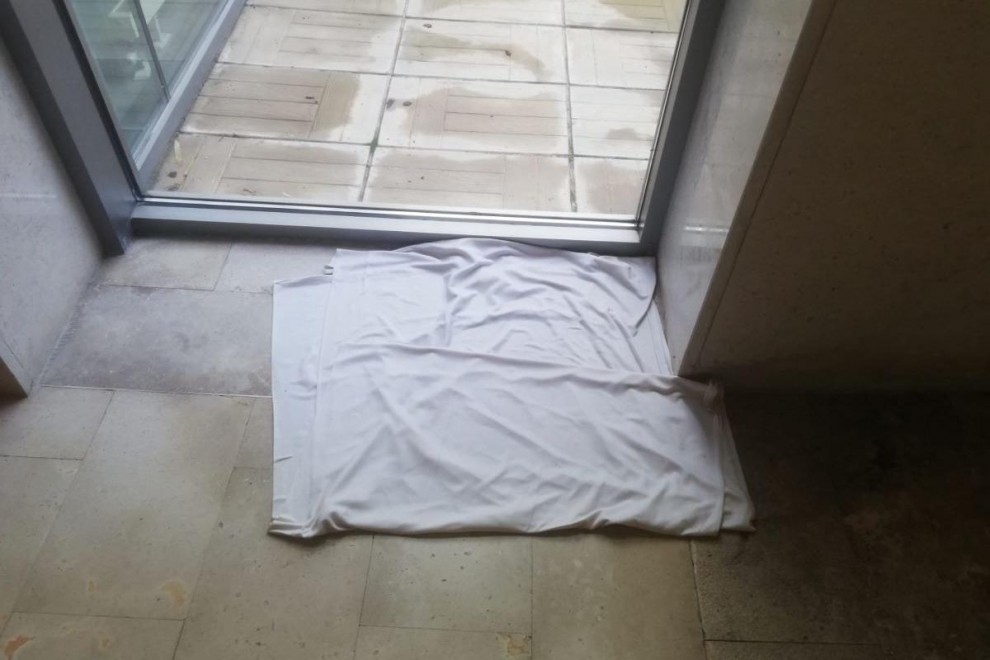 Una toalla en el suelo para evitar caídas a causa de las goteras en el Centro  Alzhéimer de la Fundación Reina Sofía.