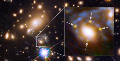 Una galaxia del cúmulo estelar MACS J1149.6 + 2223 incluye una cruz de Einstein, formada por las cuatro imágenes ampliadas (indicadas con flechas) de una remota supernova, cuya luz curvada adopta esta curiosa configuración. / NASA, ESA et al.