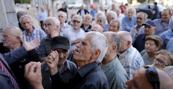 Un grupo de personas haciendo cola en un cajero de Atenas./ REUTERS