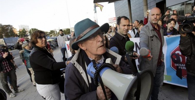 Nicanor Acosta, el activista de 76 años juzgado en A Coruña por supuesta instigación contra la Policía ante el desahucio de una octogenaria en 2013, se dirige a los medios con un megáfono hoy a las puertas del juzgado hoy en A Coruña. Acosta, que acumula