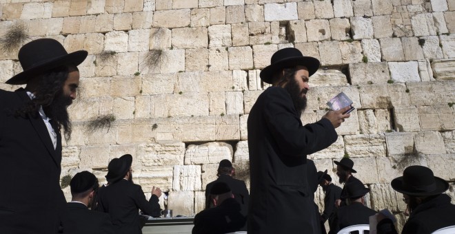 Judíos ultra-ortodoxos caminan en círculos alrededor de los demás, mientras que rezan ante el Muro de las Lamentaciones, el lugar más sagrado del judaísmo, en la Ciudad Vieja de Jerusalén. EFE / EPA / JIM HOLLANDER