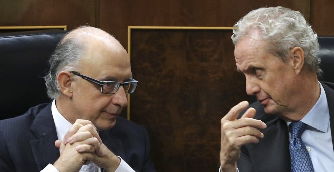 Los ministros en funciones de Hacienda, Cristóbal Montoro, y de Defensa, Pedro Morenés, en sus escaños en el Congreso de los Diputados. EFE