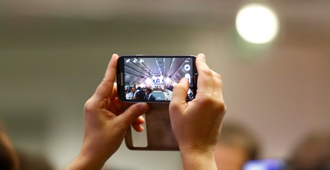 Un periodista toma una foto de la reunión de la OPEP con su smartphone. REUTERS/Leonhard Foeger