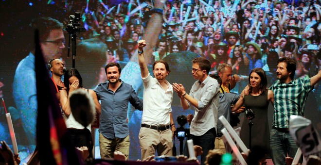 El líder de Podemos, Pablo Iglesias (centro) levanta el puño ante miles de personas en la plaza del Museo Reina Sofía de Madrid.- REUTERS