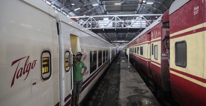 Dos personas esperan en uno de los vagones de un tren de la empresa española Talgo a su llegada a la estación central de Bombay. EFE/Divyakant Solanki