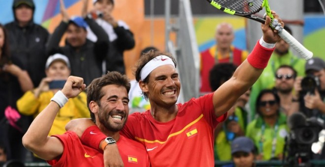 Rafa Nadal y Marc López se abrazan tras alcanzar la final en dobles. /AFP