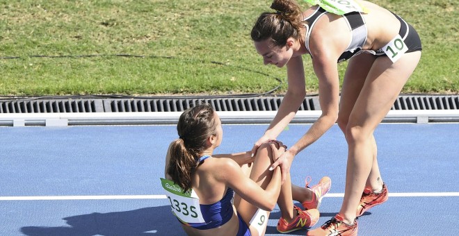 Nikki Hamblin levanta a Abbey D'Agostino en la serie de 5.000 metros. /REUTERS