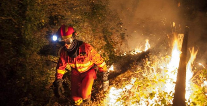 Miembros de la Unidad Militar de Emergencia (UME), realizan labores de extinción en el incendio forestal de la localidad orensana de Entrimo. / BRAIS LORENZO (EFE)