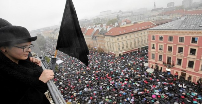 Una mujer observa la masiva manifestación en Varsovia contra la propuesta que prohibía el aborto. REUTERS /Agencja Gazeta/Slawomir Kaminski