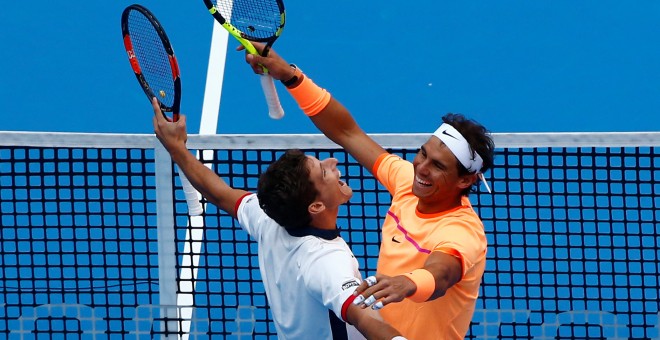 Nadal y Carreño se abrazan tras ganar en el dobles del Abierto de China. /REUTERS