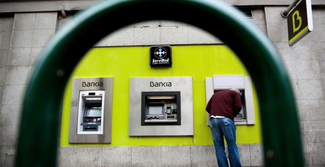 Un hombre utiliza un cajero automático en una oficina de Bankia en el centro de Madrid. REUTERS/Andrea Comas