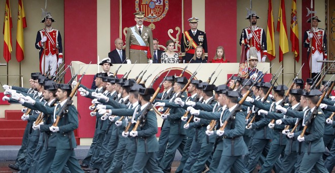 El rey Felipe VI, acompañado de su familia, presencia el paso de una unidad de la Guardia Civil durante el desfile militar del 12-O de 2016. JUANJO MARTÍN/EFE