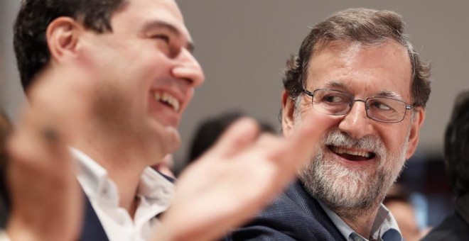 El presidente del Gobierno, Mariano Rajoy (d), junto al líder del PP andaluz, Juan Manuel Moreno (i), durante la clausura de un acto del PP de Sevilla. EFE