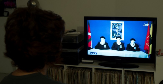 na mujer mira en televisión el anuncio de ETA de su disolución. REUTERS/Vincent West