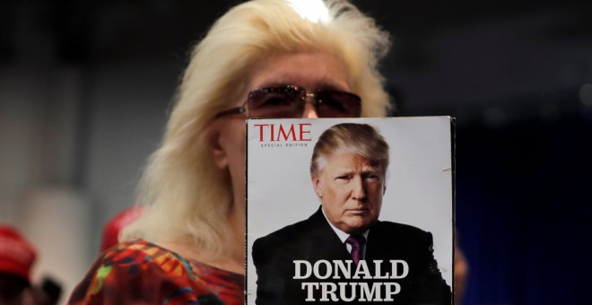 Una seguidora de Donald Trump sostiene una revista con la imagen del presidente estadounidense en portada, en un mitin electoral en Las Vegas (Nevada, EEUU). REUTERS/Mike Segar