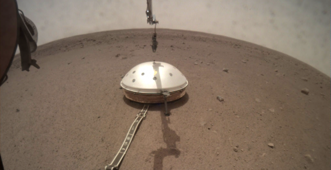 Instalación de la cúpula protectora sobre el sismómetro desde el módulo de aterrizaje Insight./JPL/NASA