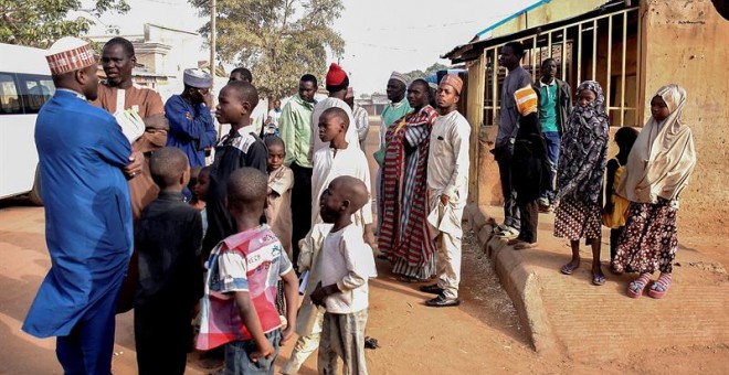 Varios votantes esperan ante un colegio electoral en Daura, Nigeria. / EFE