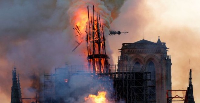 El momento del derrumbe de la aguja de la catedral de Notre Dame, presa de las llamas. - AFP