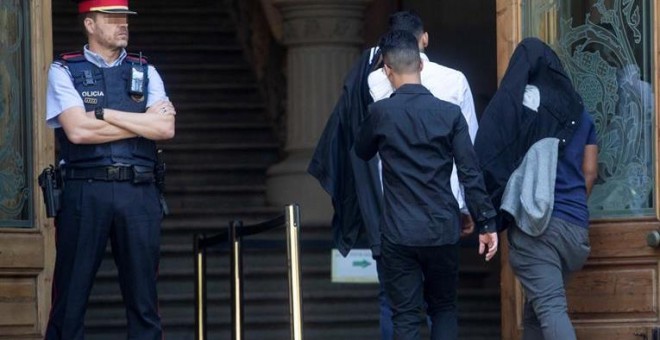 Tres dels set acusats de la violació múltiple d'una menor a Manresa (Barcelona), entrant a l'Audiència de Barcelona. (QUIQUE GARCÍA | EFE)