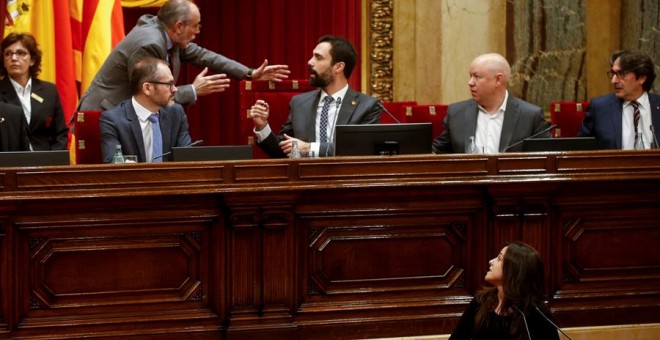 La diputada de la CUP al Parlament, Maria Sirvent, intervé aquest dimarts al ple, mentre el president de la cambra, Roger Torrent, discuteix amb el lletrat major, Joan Ridao. EFE / Quique García