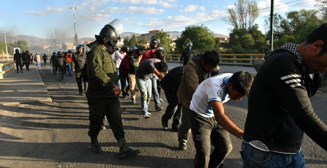5/11/2019.- Policías bolivianos custodian a los detenidos luego de los choques con grupos de manifestantes este viernes, en Cochabamba (Bolivia).