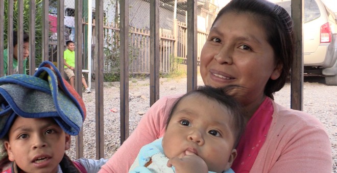 La mexicana Silvia Cayetana y sus hijos hacen fila en la calle para recibir cena en uno de los albergues situados en Nogales (México). / Aitana Vargas