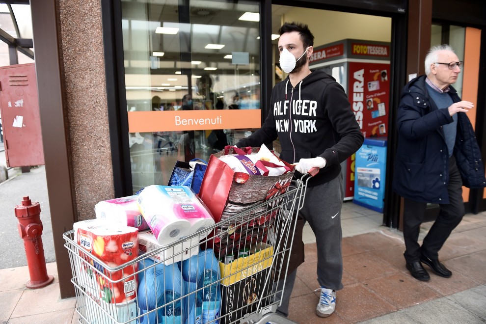 Un hombre hace acopio de productos ante el posible aislamiento en el norte de Italia. REUTERS/Flavio Lo Scalzo